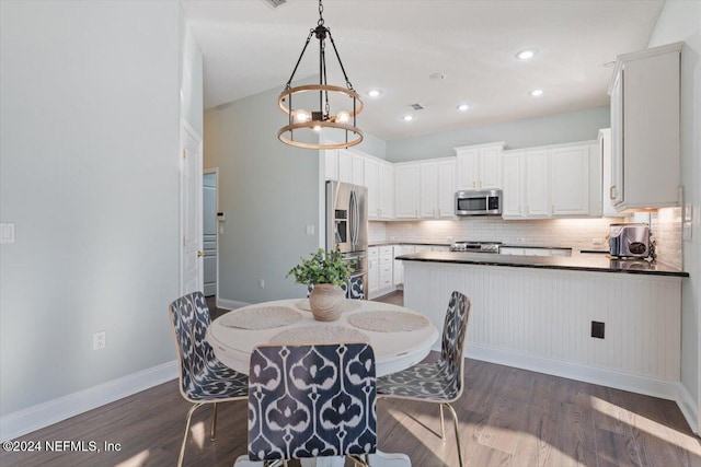 dining room featuring an inviting chandelier and dark hardwood / wood-style floors