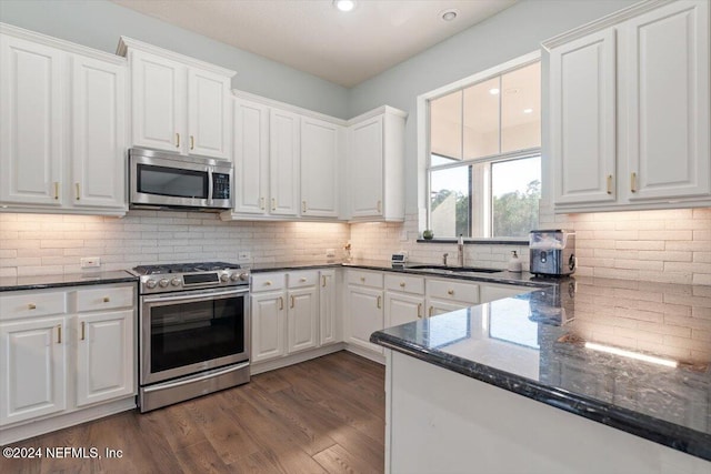 kitchen featuring appliances with stainless steel finishes, white cabinetry, sink, and dark hardwood / wood-style floors