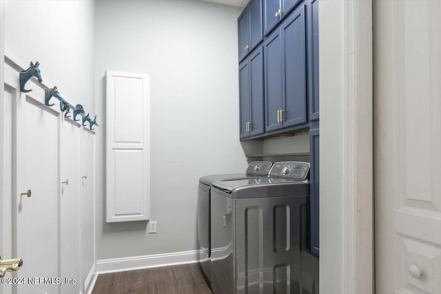 clothes washing area with dark hardwood / wood-style flooring, cabinets, and washer and clothes dryer