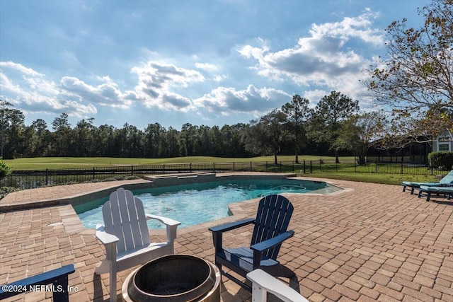 view of pool with a patio area and a lawn