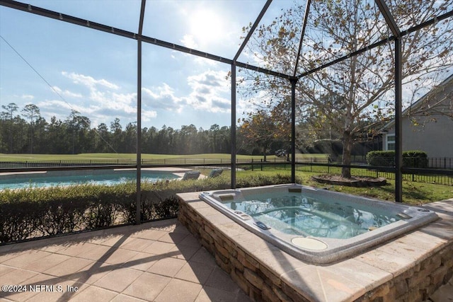 view of swimming pool featuring glass enclosure and an outdoor hot tub