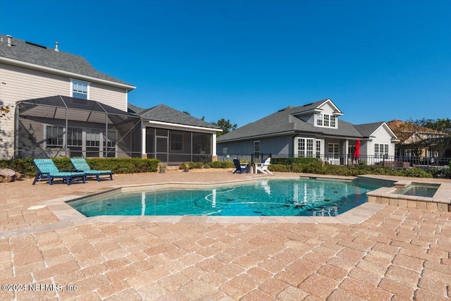 view of swimming pool featuring a patio area and a sunroom