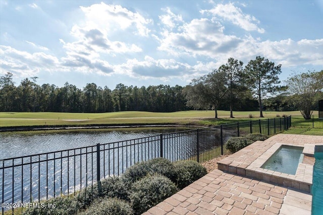 view of swimming pool featuring a water view, an in ground hot tub, a patio, and a yard