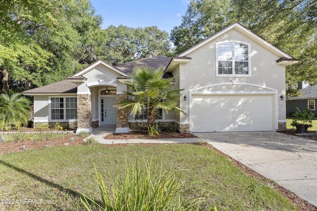 view of front property featuring a garage and a front lawn