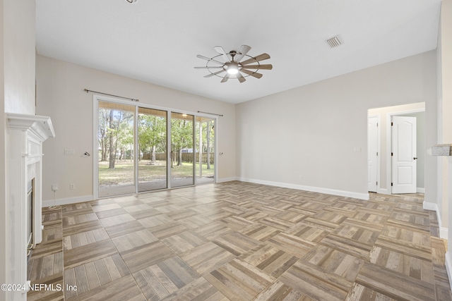 unfurnished living room featuring light parquet flooring and ceiling fan