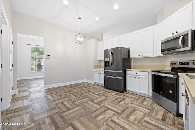 kitchen featuring appliances with stainless steel finishes, hanging light fixtures, a chandelier, light parquet floors, and white cabinets