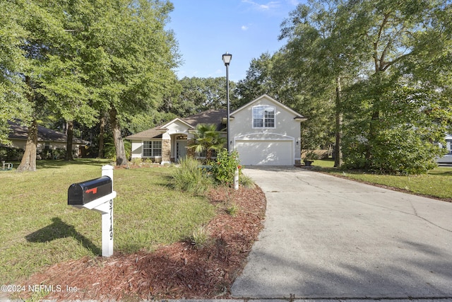 view of front of house featuring a front lawn and a garage