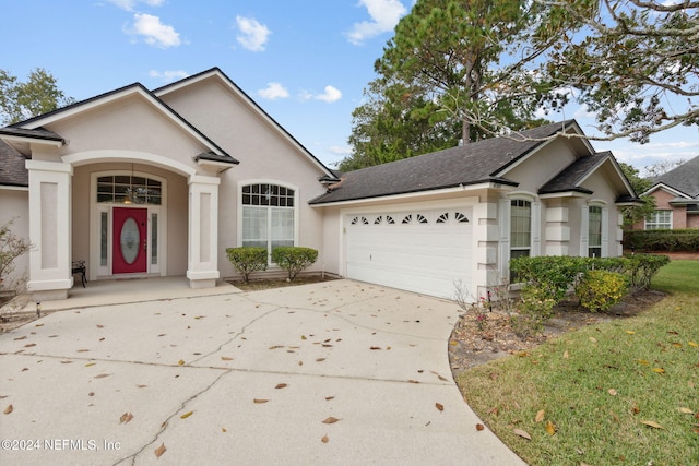 view of front of property featuring a garage and a front lawn