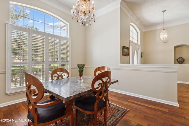 dining space featuring crown molding, dark hardwood / wood-style flooring, and a wealth of natural light