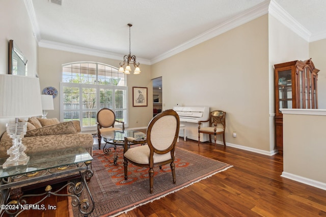 living room with ornamental molding, a chandelier, and dark hardwood / wood-style floors