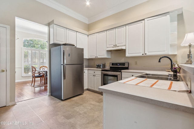 kitchen with white cabinetry, light hardwood / wood-style flooring, ornamental molding, sink, and stainless steel appliances