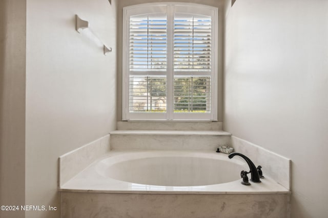 bathroom with tiled tub