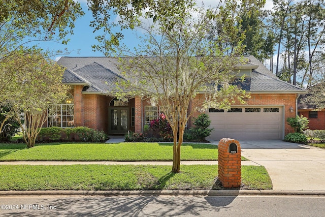 view of front facade with a front yard and a garage