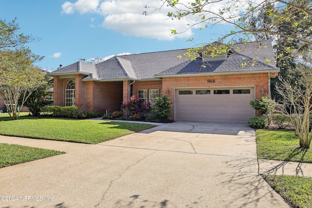 ranch-style house featuring a front lawn and a garage