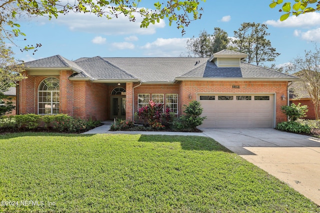 ranch-style house featuring a front lawn and a garage