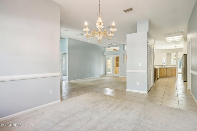 spare room featuring sink and light carpet