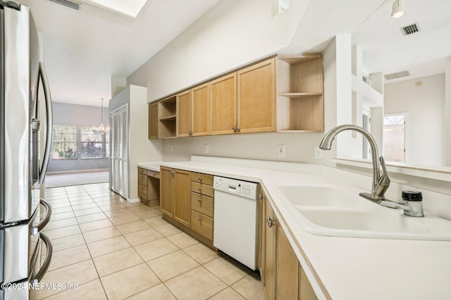 kitchen featuring stainless steel fridge, a chandelier, white dishwasher, and light tile patterned floors