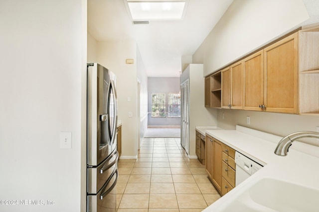 kitchen with sink, light tile patterned flooring, and stainless steel fridge with ice dispenser