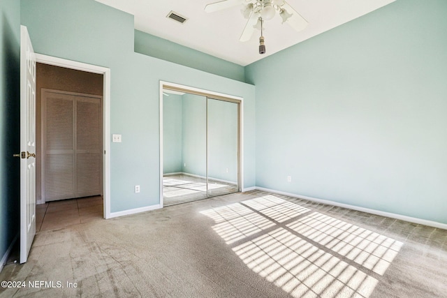 unfurnished bedroom with carpet floors, a closet, and ceiling fan