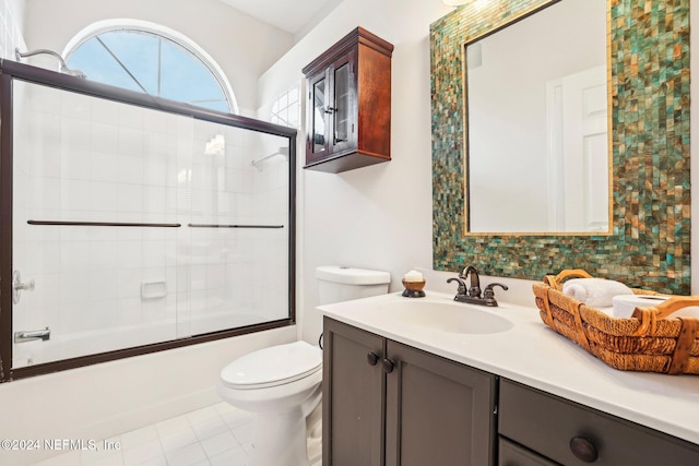 full bathroom with vanity, toilet, tile patterned floors, and shower / bath combination with glass door