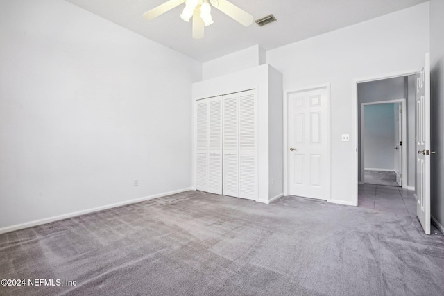 unfurnished bedroom featuring carpet floors, a closet, and ceiling fan