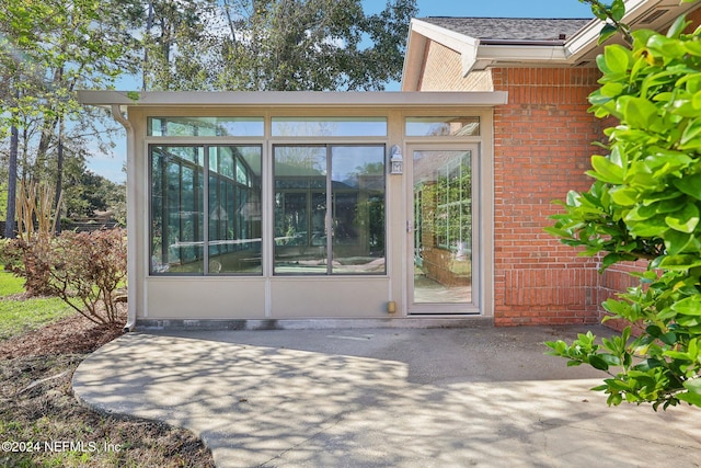 doorway to property with a patio area