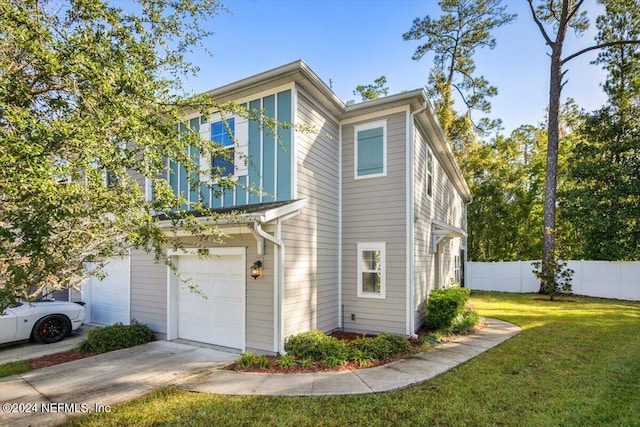 view of property exterior featuring a lawn and a garage