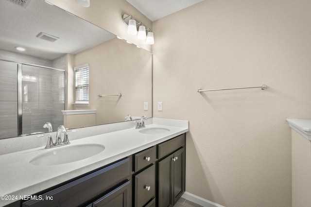 bathroom featuring vanity and a shower with shower door