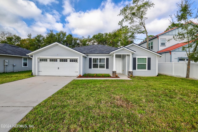 view of front of property featuring a front yard and a garage