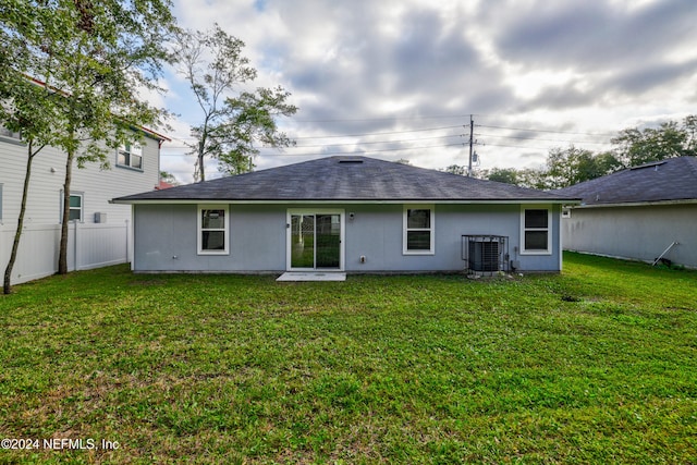 back of property featuring a lawn