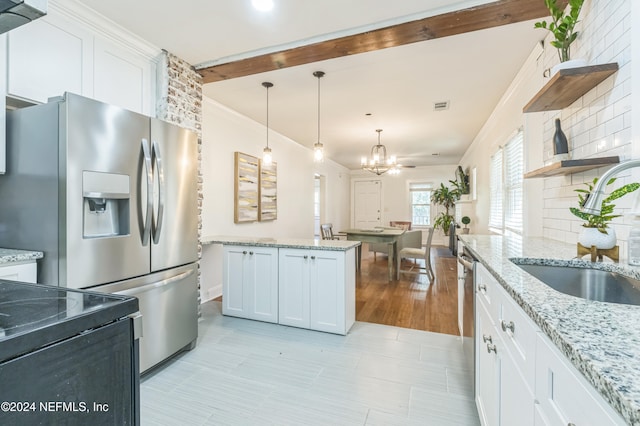 kitchen featuring stainless steel refrigerator with ice dispenser, white cabinetry, light stone countertops, and sink