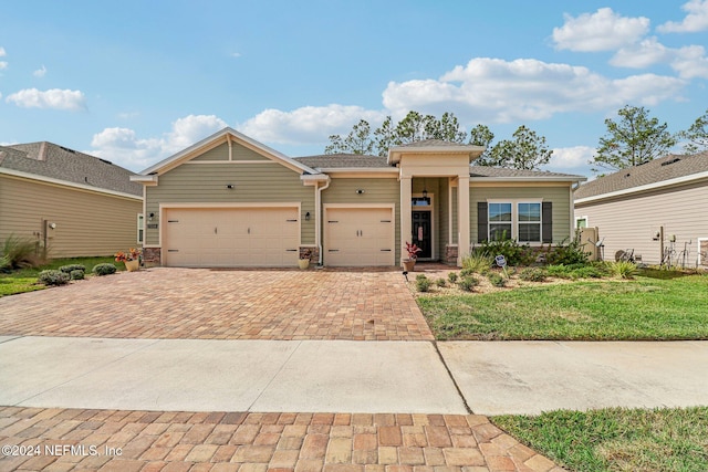 view of front of home with a front lawn and a garage