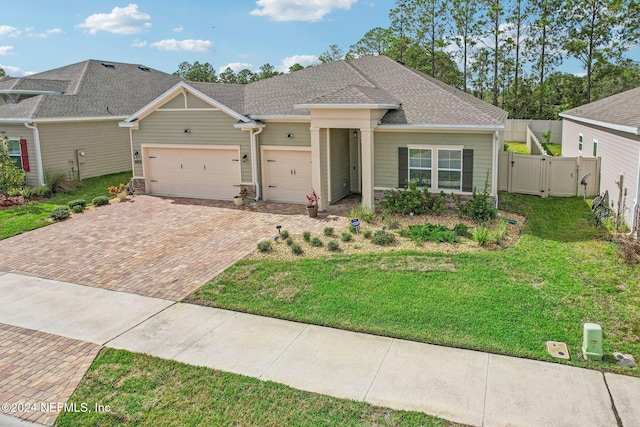 view of front of property featuring a front yard and a garage