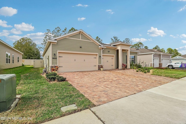 view of front facade featuring a front yard and a garage