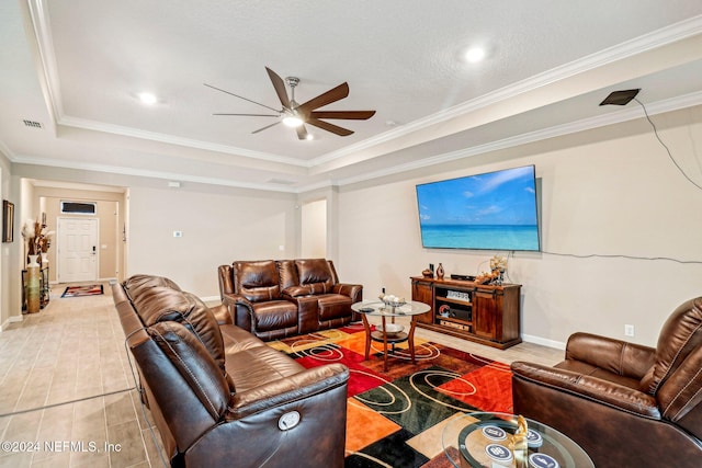 living room with crown molding, a tray ceiling, a textured ceiling, and ceiling fan