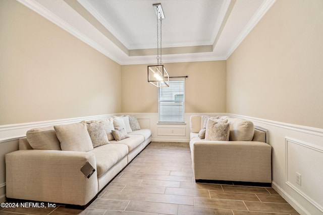 living room featuring ornamental molding and a tray ceiling