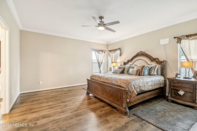 bedroom with multiple windows, wood-type flooring, and ceiling fan