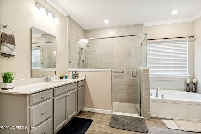 bathroom with vanity, crown molding, and shower with separate bathtub