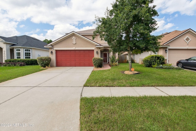 view of front of house featuring a front yard and a garage