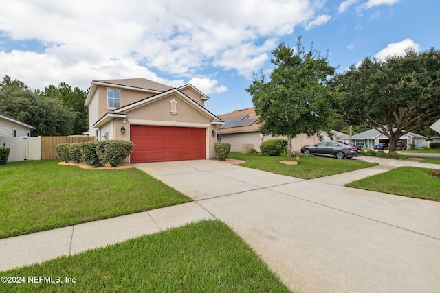 view of front of house featuring a front lawn and a garage