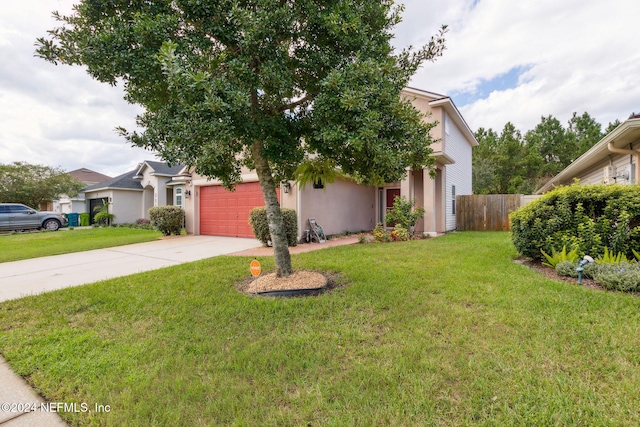 view of front of house featuring a front yard and a garage