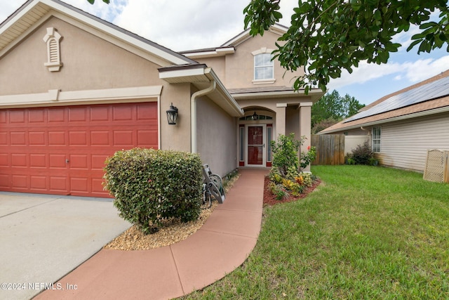 view of front facade featuring a front yard and a garage