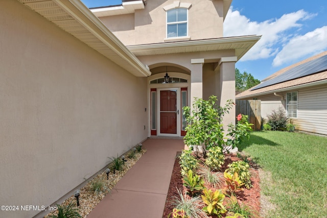 property entrance with a yard