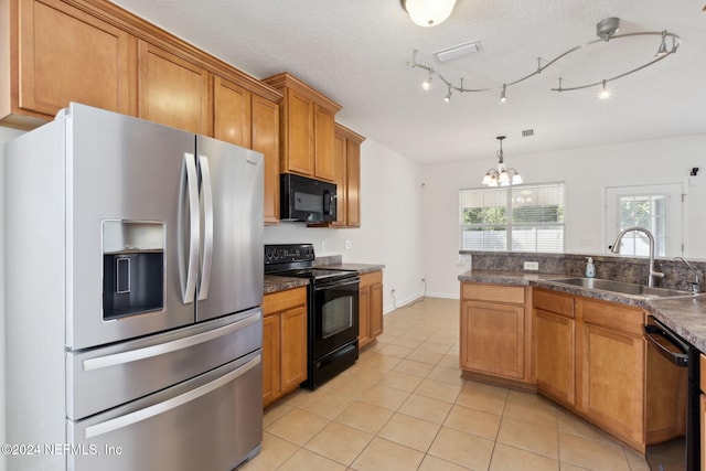 kitchen featuring black appliances, sink, a textured ceiling, pendant lighting, and a notable chandelier