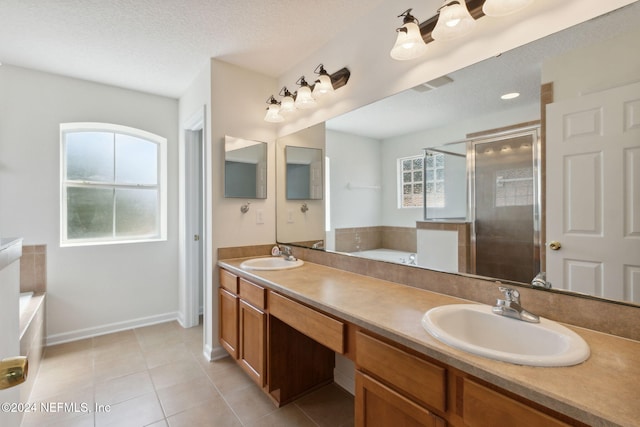 bathroom with vanity, a textured ceiling, tile patterned floors, and separate shower and tub