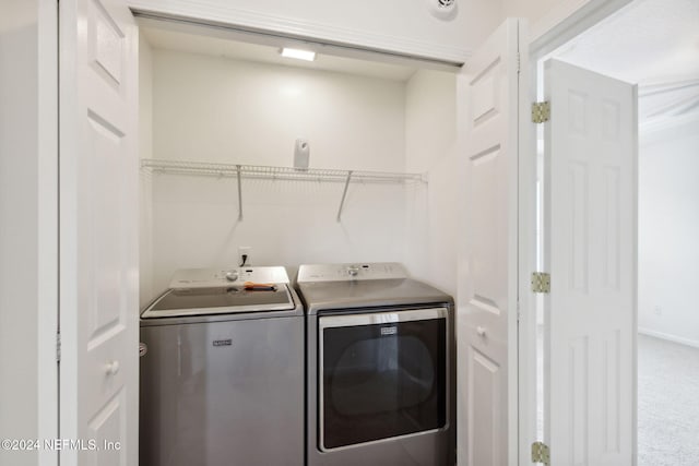 laundry area featuring washer and dryer and carpet