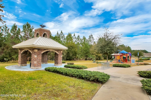 view of home's community with a playground and a lawn