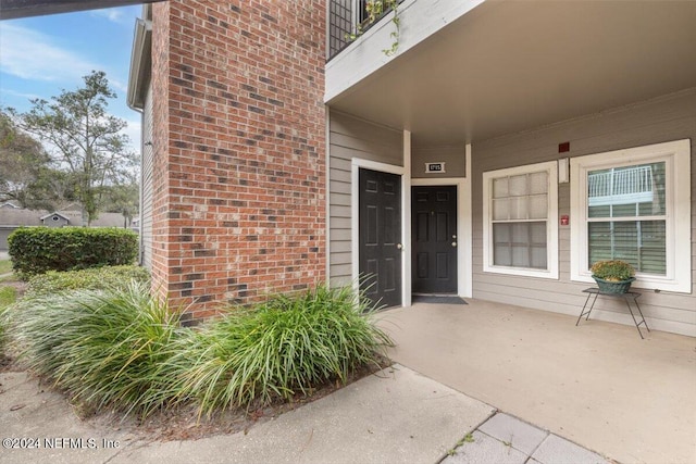 entrance to property with a balcony