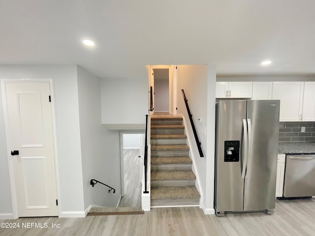 staircase featuring hardwood / wood-style floors