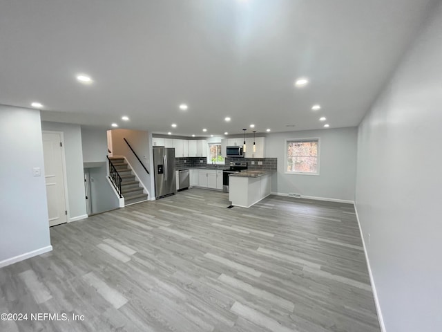 unfurnished living room with light wood-type flooring